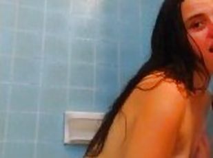Foamed water streams pour down shower spy cam girl